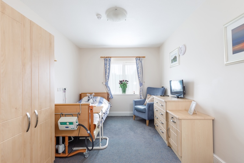 bedroom with blue furniture and nursing equipment