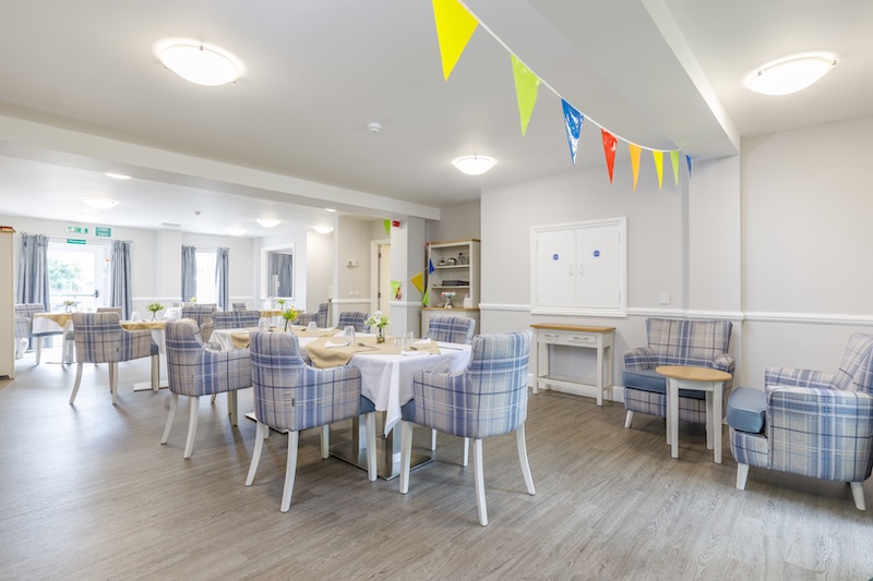 dining room with blue chairs and coloured flags